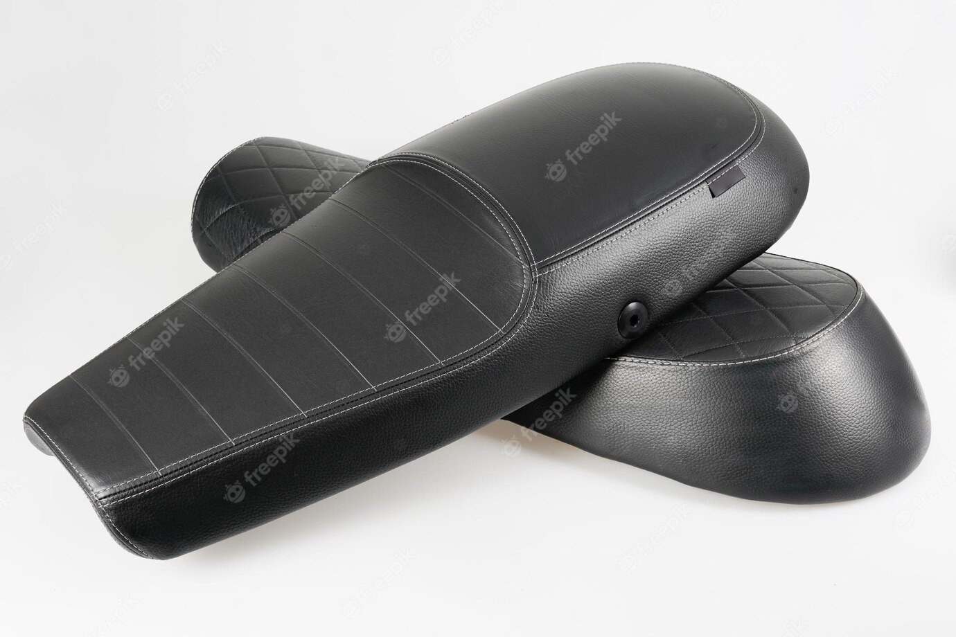 black-leather-texture-motorcycle-seat-with-two-models-vintage-motorbike-saddle-white-background_100800-6768